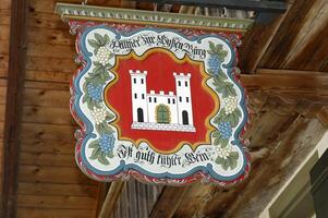 a sign hanging from a building with a castle on it photo