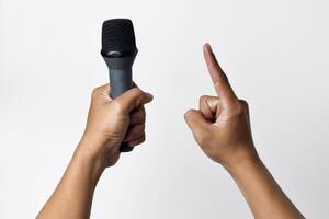 sian man holding microphone and pointing upward on white background photo