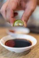 Hands squeeze a lime photo