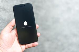 Bangkok, Thailand - June 9, 2025 Apple logo loading and installing operating system ios on the screen. photo