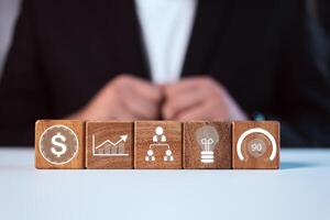 Business performance indicators, Data management system icon on wooden block to make report. photo