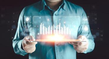 Businessman or analyst working with business analytics and data management system on virtual screen. photo