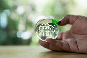 Hand holding globe with carbon neutral and net zero,save planet in Hands, Save the world, save environment,CO2 emission reduction carbon photo