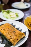 Steamed fish curry custard in banana leaf photo