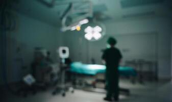 Blurred image of healthcare worker standing in operating room or surgical room in hospital. photo