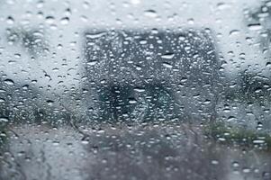 Dew drop on the car glass window during raining. Dew is the moisture that forms as a result of condensation. photo
