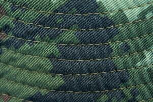 Close up of textured camouflage military uniform of soldier. photo