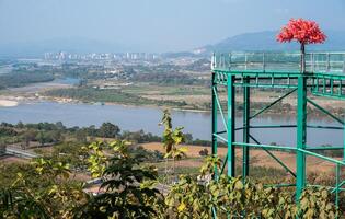 Scenery view of Ton Pheung district on the banks of Mekong River in Bokeo Province, Laos seen from Chiang Saen district of Chiang Rai province in Thailand. photo