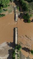 Aerial view of small bridge in Mae Yao district of Chiang Rai province collapsed after Kok river flooded. photo