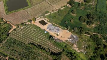 High angle view of the garbage field in rural Thailand. It provides a specific place for the disposal of garbage. photo