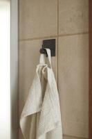 Face towel in black hook photo