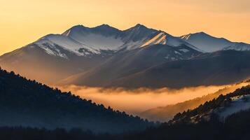 A mountain range with fog and snow photo
