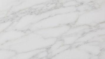 Clean white marble texture with delicate gray veining, providing a minimal and elegant look. Ideal for modern architecture, branding, or web design backgrounds photo