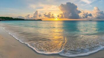 A beach with a sunset and a boat on the water photo