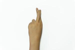 Hand isolated on white background with fingers crossed photo