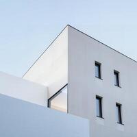 Geometric architecture, minimalist building design against clear sky backdrop photo