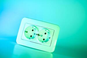 Electrical double socket for connecting devices in azure emerald photo