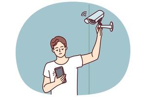 Man sets up WIFI camera and monitors result via phone to secure apartment vector