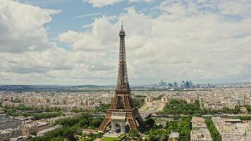 Close up of Eiffel Tower during restoration. A bird's eye view from a drone, a general view of the historic center of Paris. Fluffy white clouds. Paris, France photo
