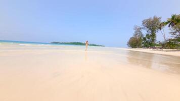 Active young woman running on a tropical paradise beach. Concepts of escape from the crowd, empty paradise, freedom, active lifestyle, beach vacation. video