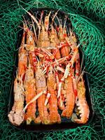 Fresh crayfish roasted using the rustic fisher method photo