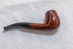 Hand holding luxurious pipe in selective focus and smooth background 100 photo