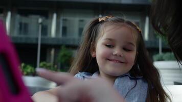 Young girl enjoys interactive learning on a device at a park in spring video