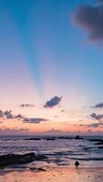 Sunset at the beach with clouds and rocks video