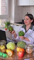 A nutritionist conducts an online consultation with patients at a table with various fruits and vegetables. Fresh products maintain health and improve well-being. Nutrition concept, medical center video