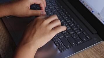 Close-up of hands typing on laptop keyboard. Concept of remote work, freelance job, digital lifestyle, online communication, and modern working environment video