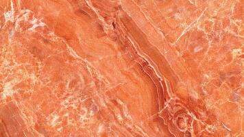 Orange marble with natural veining and deep warm tone photo