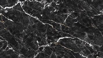 Dark marble with white natural veining and dense surface pattern photo
