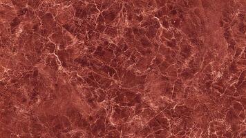 Red marble texture with natural white veining and polished surface photo