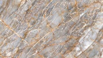 Cool gray marble with white and bronze linear veining smooth polished surface photo