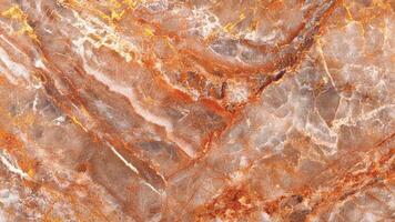 Multicolored marble with strong orange and beige veining and layered texture photo