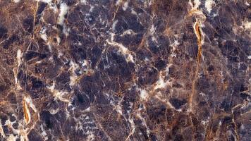 Dark navy and gold veined marble dramatic and rich stone surface photo