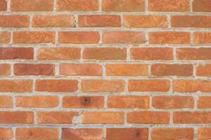 Brick wall in different shades of red and orange, Spoon masonry in half brick, attractive textured background in rustic style, aged surface, photo
