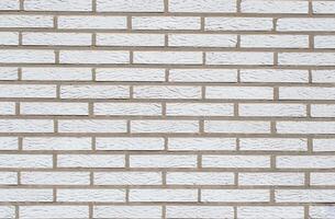 White brick background, textured surface showing spoon masonry, ideal for various design and architectural projects, photo