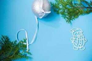 New Year's white ball and snowman on a background with a fir branch photo