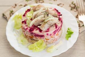 Homemade vegetable salad with potatoes, carrots and fish . photo