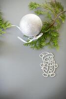 New Year's white ball and snowman on a background with a fir branch. photo