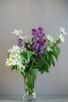 floral arrangement of lilacs on a gray background photo
