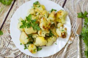 Rustic vegetable dish with cabbage and herbs, top view photo
