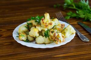 Rustic vegetable dish with cabbage and herbs, top view. photo