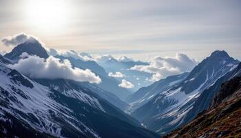a sweeping mountain panorama where rocky peaks break through clouds and snow glistens under a pale sun. photo