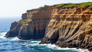 a sea cliff with layered sedimentary rock, revealing thousands of years of geological history. photo