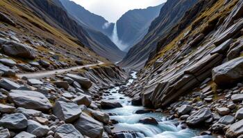 a rugged mountain ravine filled with jagged rocks and cascading water, echoing with the distant rumble of falls hidden from view. photo