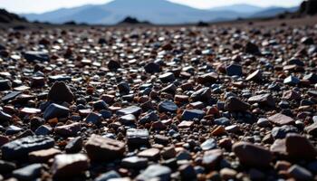 a field of obsidian shards scattered by a long extinct volcano, sparkling like glass under the sun. photo