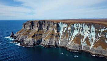 a tundra bluff above the ocean, with permafrost patterns and deep blue ice visible in the cliff walls. photo