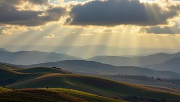 a rolling hillscape beneath soft cloud shadows, each curve lit differently as sunlight breaks through. photo